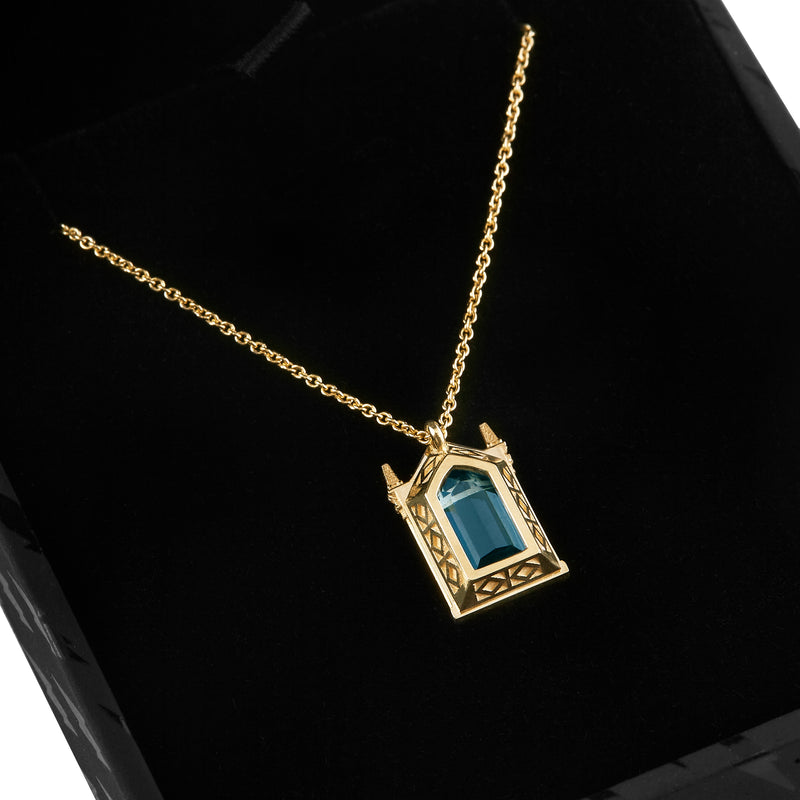 Back side of Officially licensed Harry Potter Mirror of Erised necklace in solid 14k yellow gold set with natural topaz resting in a black ring box on a white background. Also available in sterling silver, 14k white gold, 18k yellow gold, and platinum.
