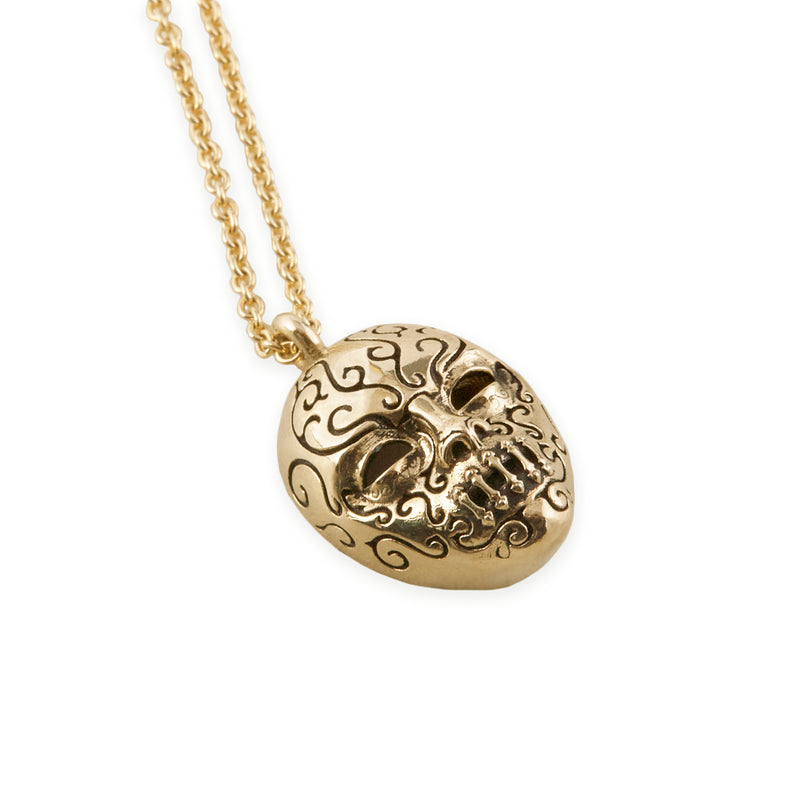 Officially licensed Bellatrix LeStrange death eater mask pendant in solid 14k gold on a white background. Also available in sterling silver, 14k white gold, and platinum.