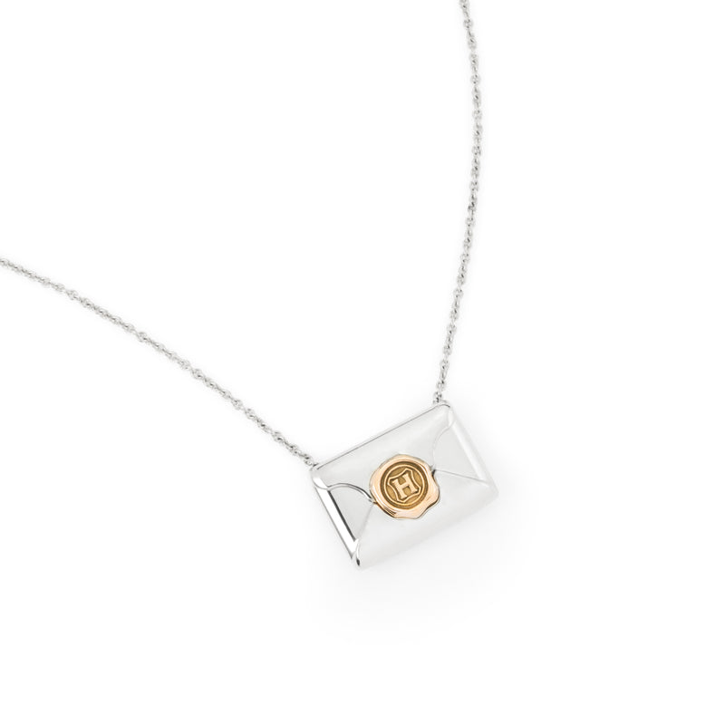 Officially licensed Harry Potter Hogwarts Acceptance Letter Necklace in sterling silver on a white background. Also available in 14k yellow or white gold, 18k yellow gold, and platinum.
