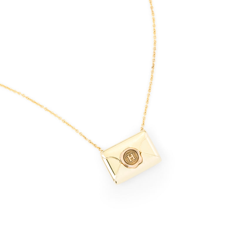 Officially licensed Harry Potter Hogwarts Acceptance Letter Necklace in solid 14k yellow gold on a white background. Also available in sterling silver, 14k white gold, 18k yellow gold, and platinum.