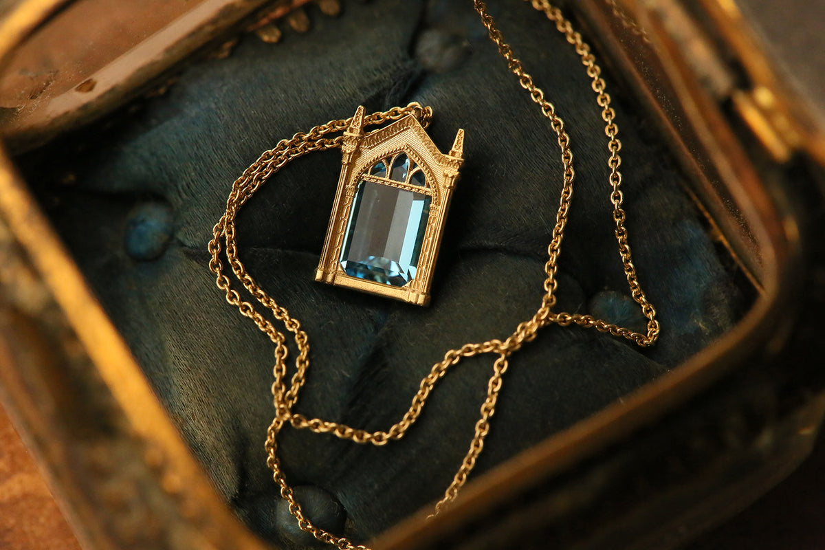 Officially licensed Harry Potter Mirror of Erised necklace in solid 14k yellow gold set with natural topaz nestles in a vintage ring box. Also available in sterling silver, 14k white gold, 18k yellow gold, and platinum.